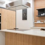 Sleek and contemporary kitchen with wooden finishes and modern appliances.